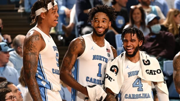 Dec 1, 2021; Chapel Hill, North Carolina, USA; North Carolina Tar Heels forward Armando Bacot (5) and guard Leaky Black (1) and guard R.J. Davis (4) react on the sidelines in the second half at Dean E. Smith Center. Mandatory Credit: Bob Donnan-USA TODAY Sports
